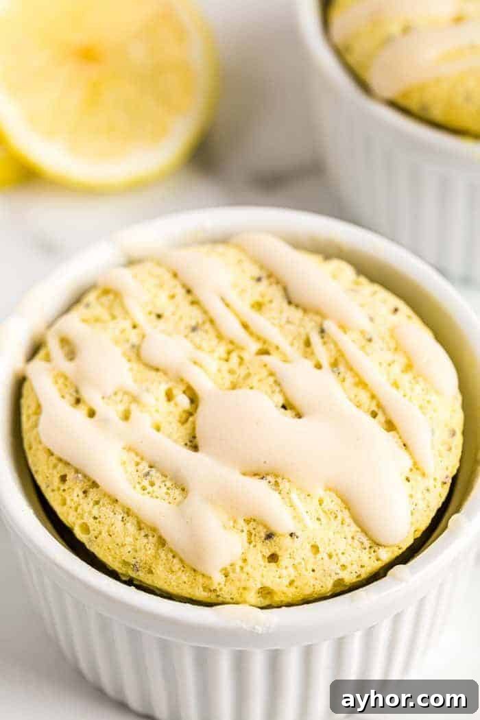 closeup of a keto muffin in a mug with easy glaze keto icing on top
