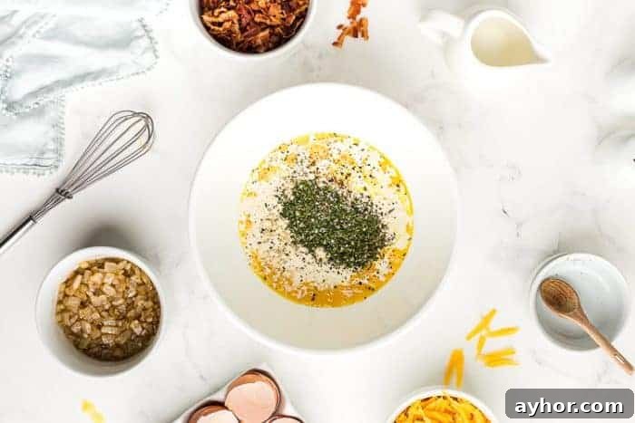 bowl containing eggs and spices on a table for keto crustless quiche