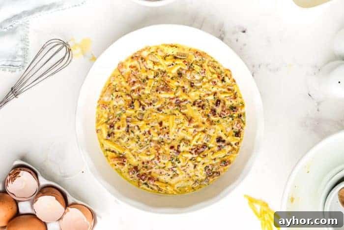 crustless quiche keto batter poured into a pie pan