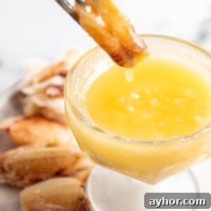 Garlic Butter Sauce Recipe for Seafood and Shellfish 10 A piece of crab meat being dunked into a bowl of butter.
