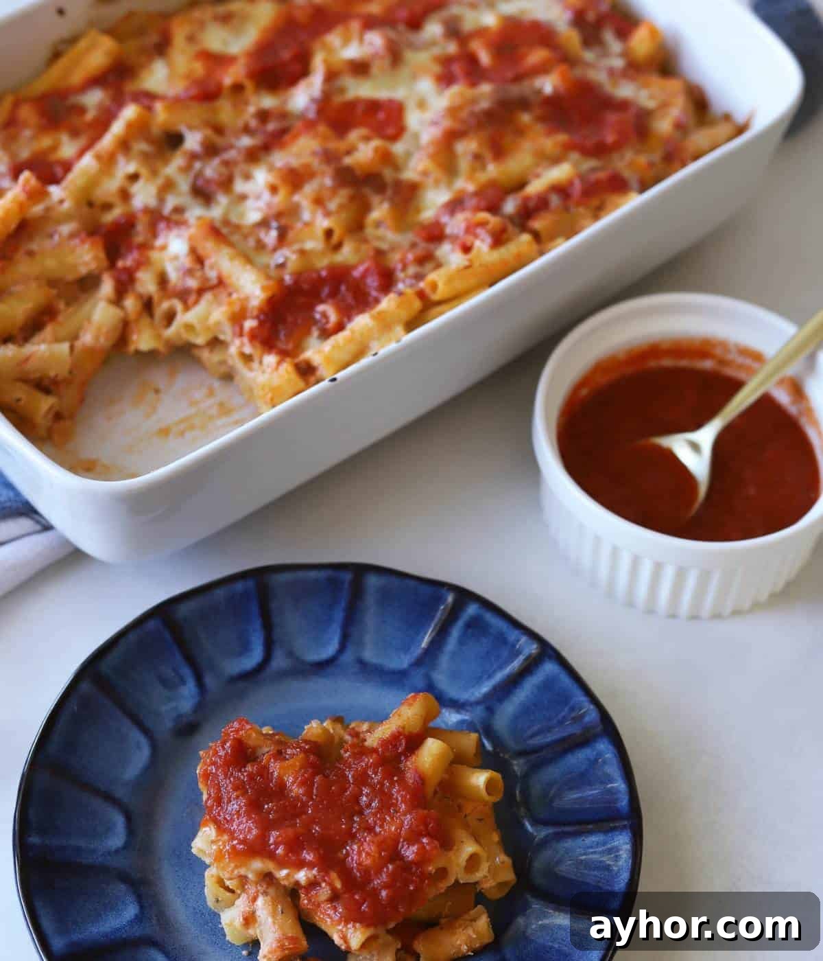Vegetarian Baked Ziti with Cheesy Tomato Sauce 11 Casserole dish full of baked ziti with plate in front.