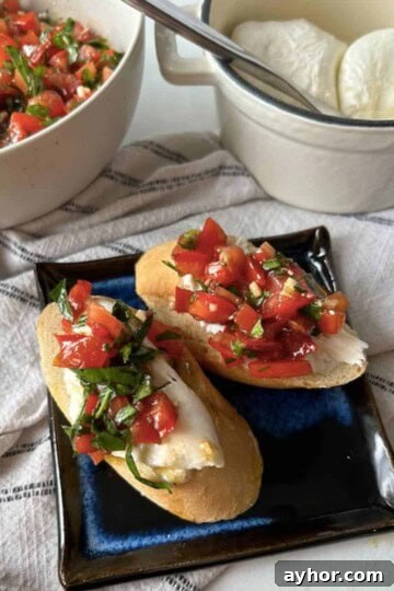Creamy Burrata Toasts topped with bruschetta.