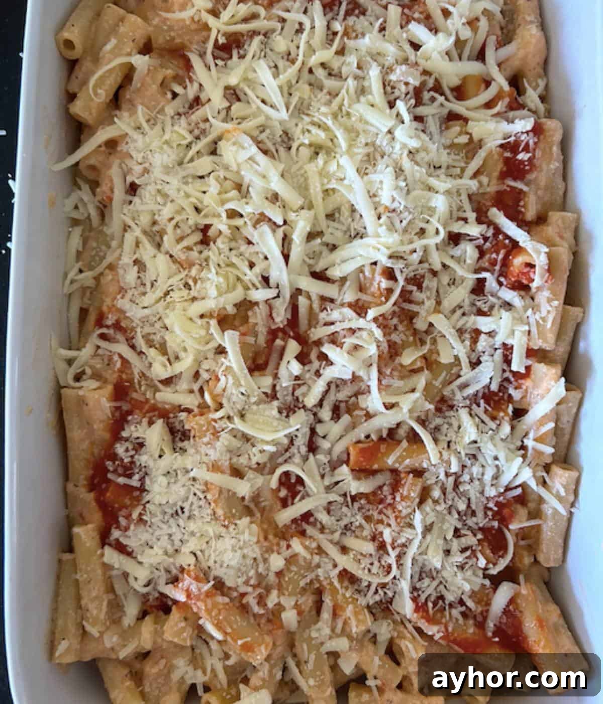 Vegetarian Baked Ziti with Cheesy Tomato Sauce 9 No meat baked ziti in casserole dish topped with cheese.