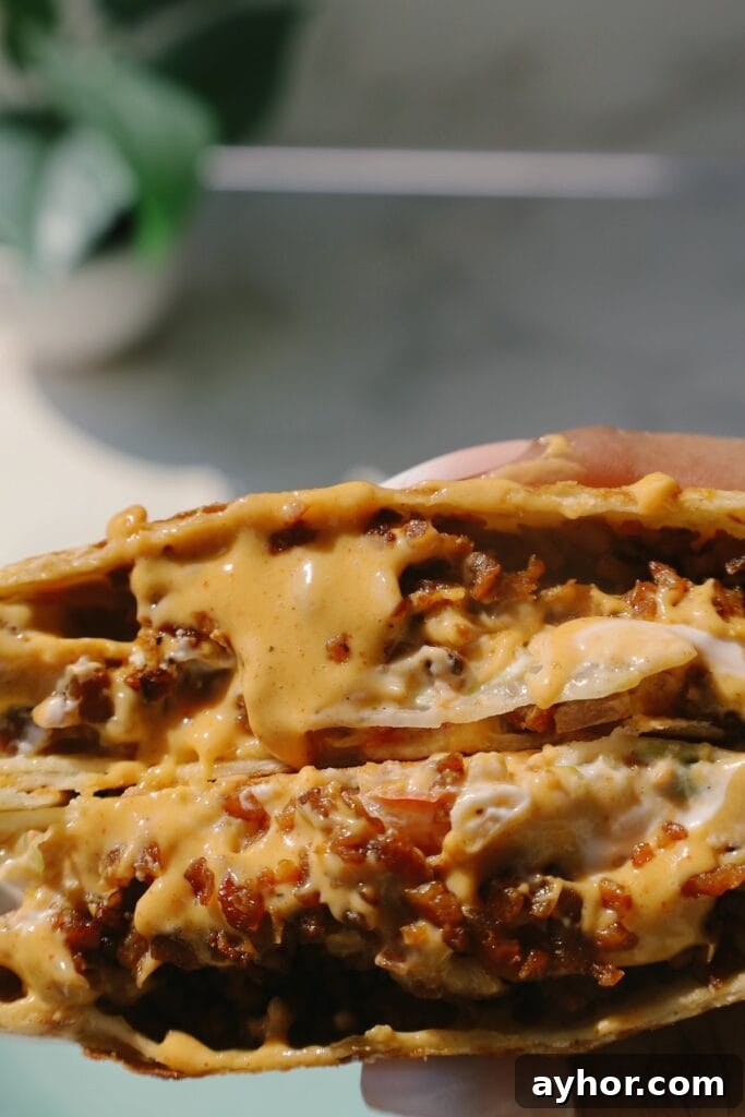 Vegetarian Crunchwrap Supreme Recipe: How to Make It at Home 2 crunchwrap supreme close up with cheese
