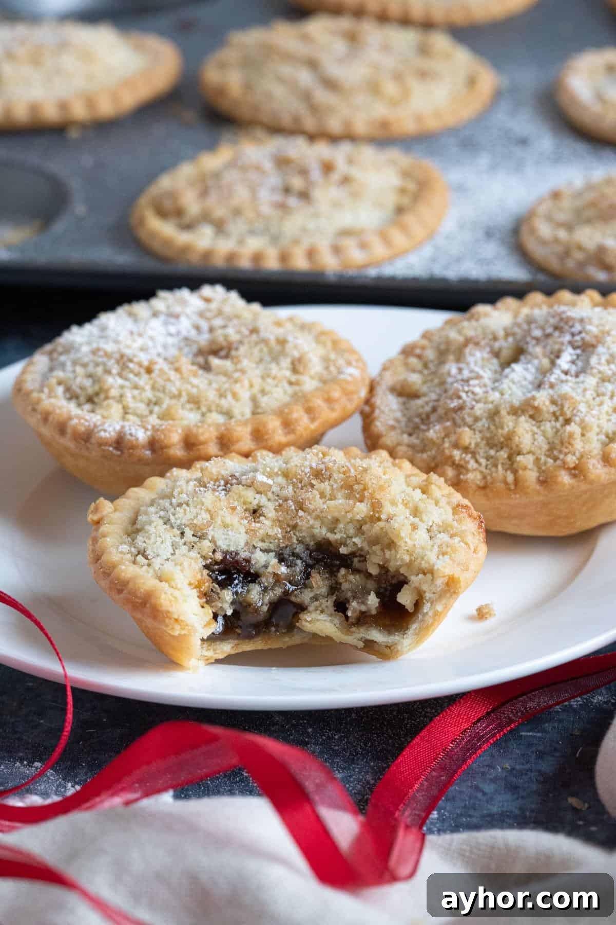 Crumble-Topped Mince Pies Recipe for Festive Holidays 2 Crumble topped mince pies on a plate.