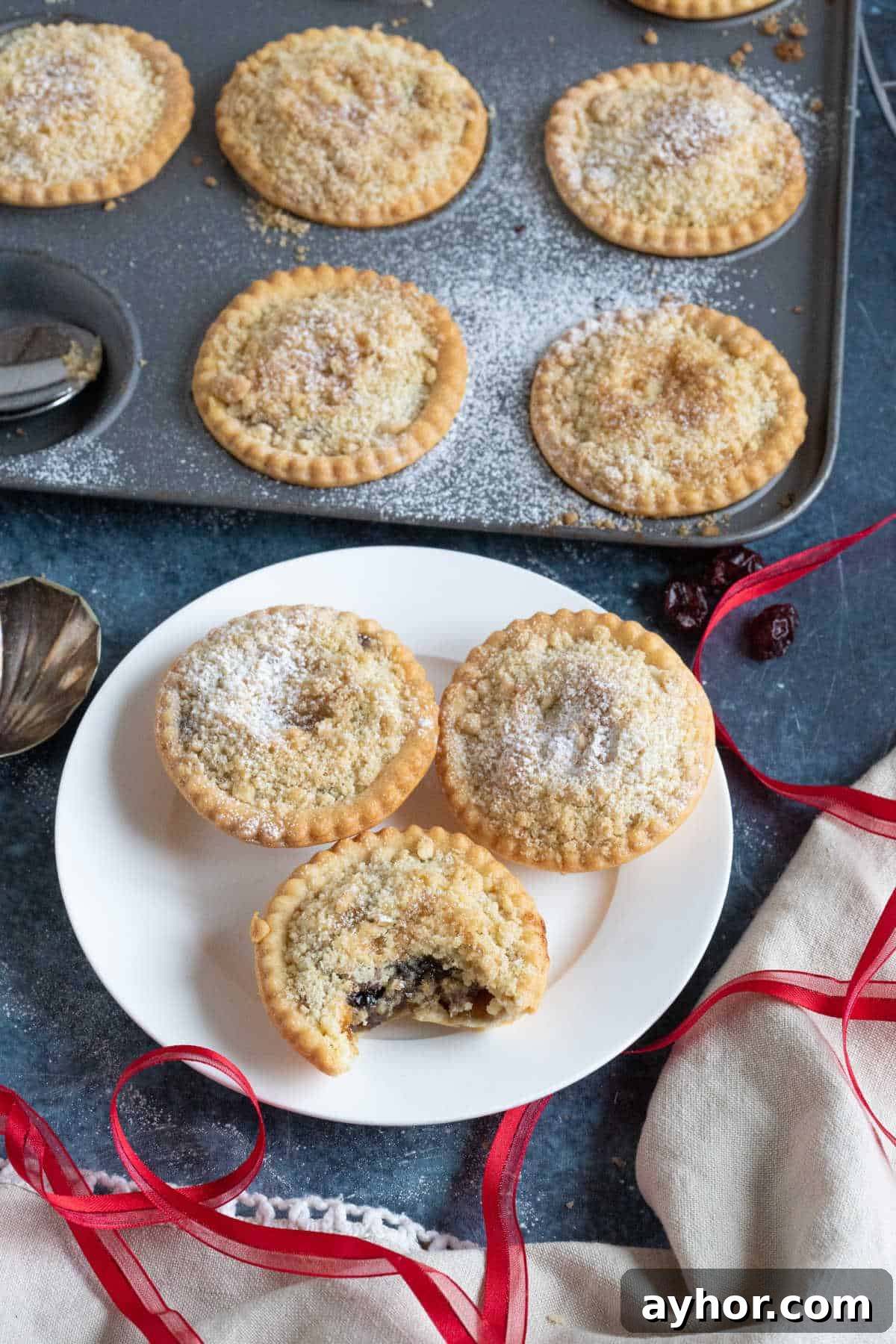 Crumble-Topped Mince Pies Recipe for Festive Holidays 8 Crumble topped mince pies in a bun tin.