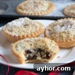Crumble-Topped Mince Pies Recipe for Festive Holidays 9 Crumble topped mince pies on a plate.
