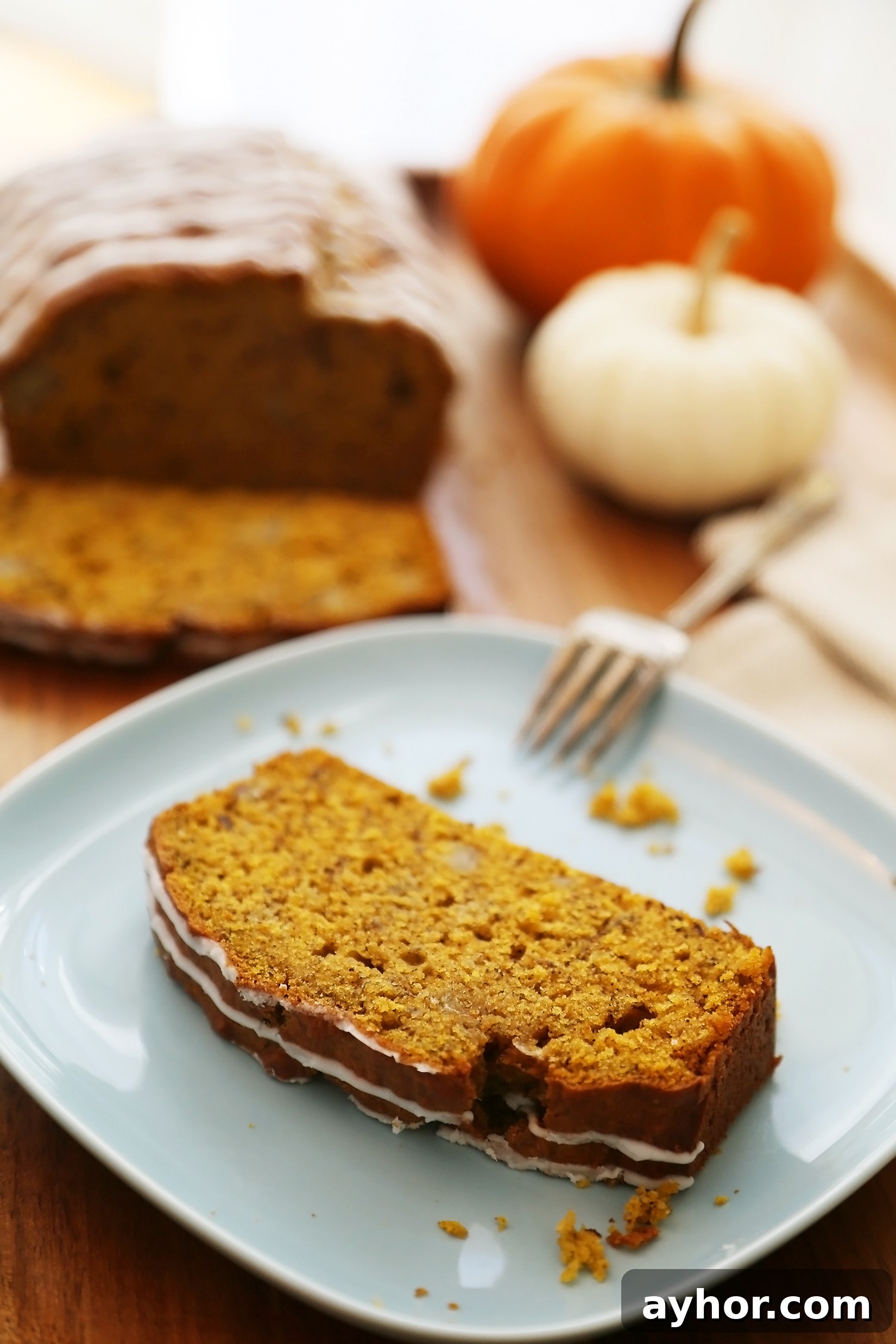 Pumpkin Banana Bread with Vanilla Glaze - Super moist, fluffy pumpkin-banana bread easily baked from scratch! Perfect for gifting or enjoying for breakfast, brunch or dessert.