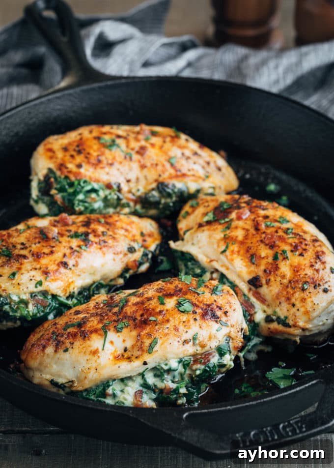 pan-roasted spinach and cheese stuffed chicken breasts in a cast iron pan