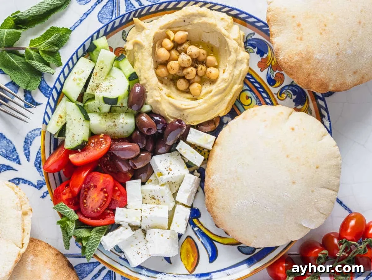 mezze platter with pizza bread, olives, and vegetables