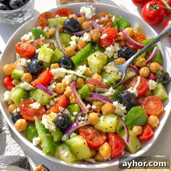 Greek chickpea salad with a rustic silver fork.