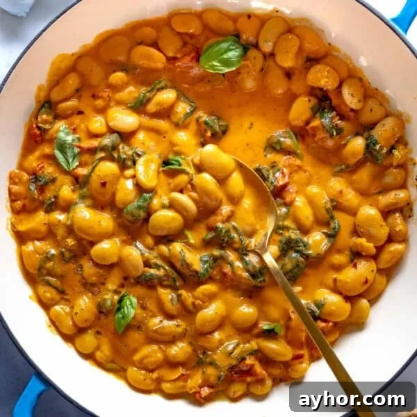 Marry me butter beans in a blue skillet.