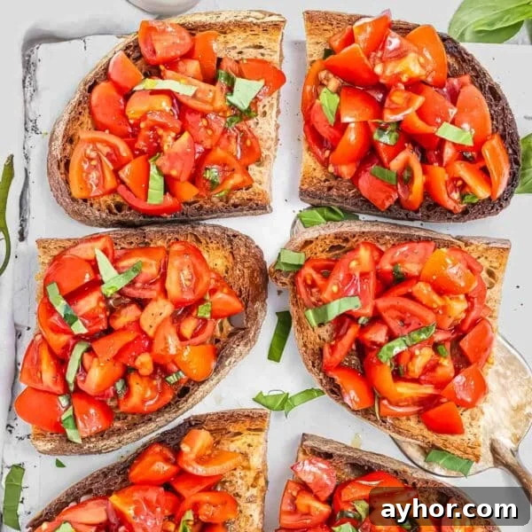 Bruschetta with tomatoes on a white cutting board ready for a healthy starter.