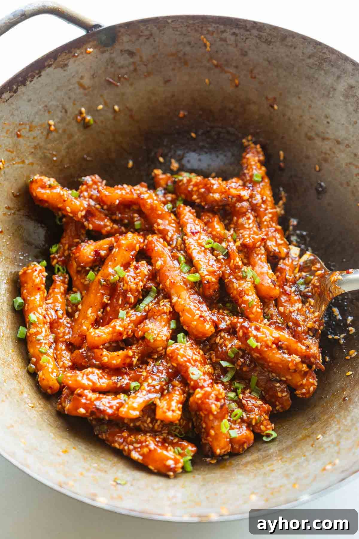 Crispy Honey-Chili Potatoes Recipe — Sweet Spicy Fried Potatoes 4 crispy honey chilli potatoes in a wok straight from the stove