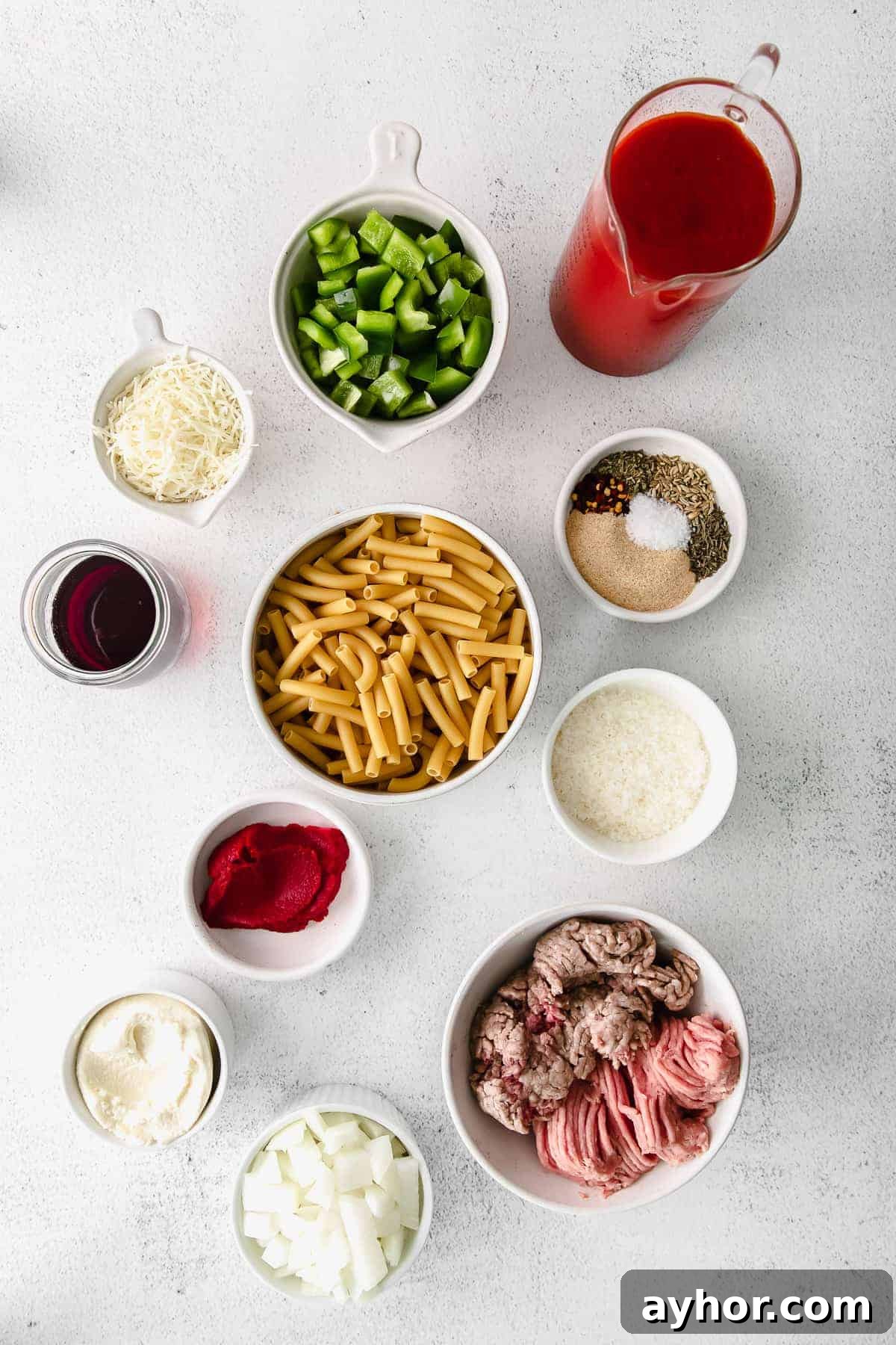 all of the ingredients for baked ziti in small dishes on the counter top. 