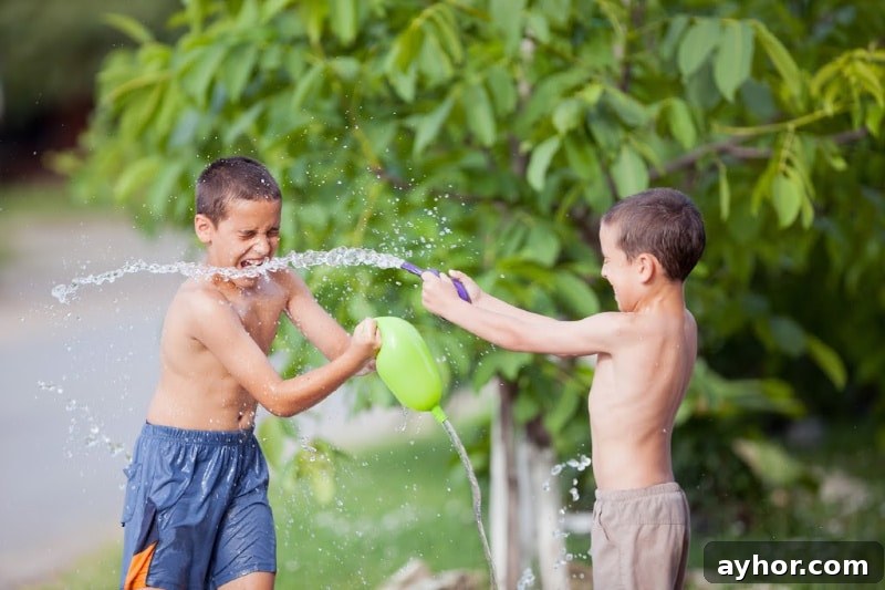 13 Splashy Outdoor Water Games Kids Will Love 4 2 boys playing with water balloons