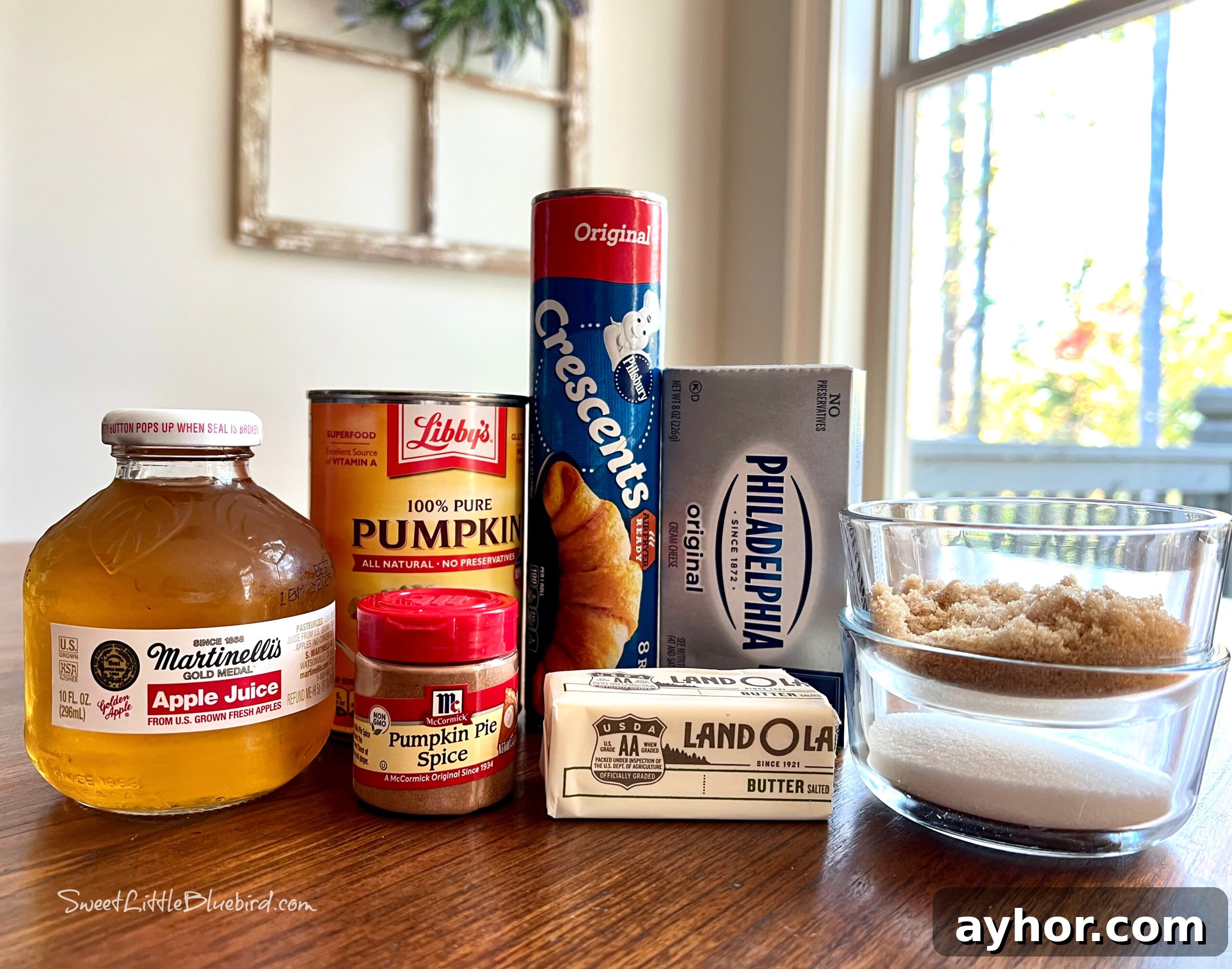 This is a photo showing all of the ingredients needed to make the Pumpkin Dumplings displayed on brown wood kitchen table. 