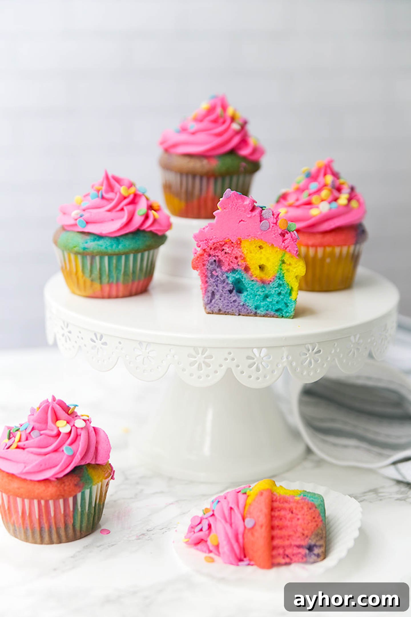 Rainbow marble cupcakes on a cakestand.
