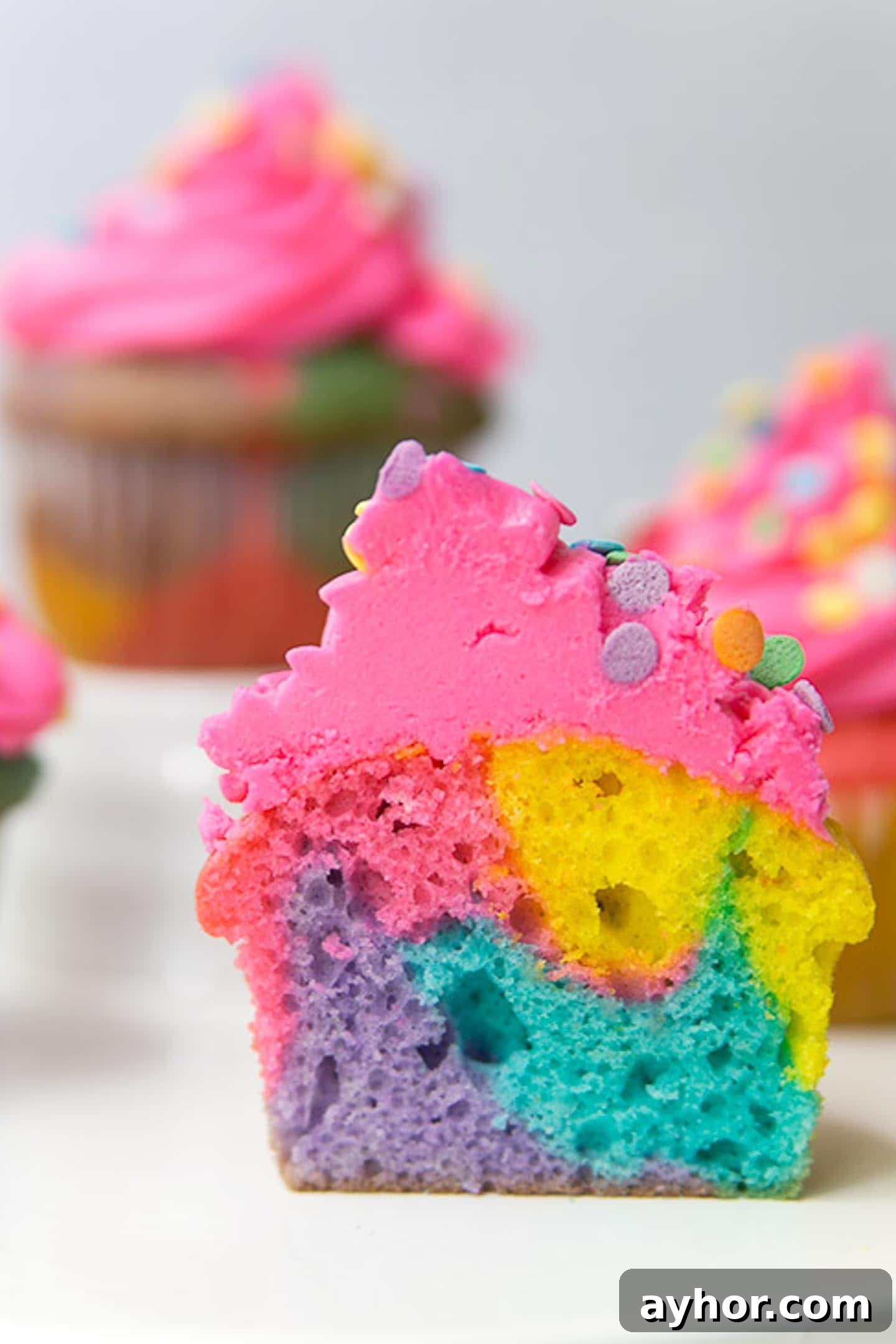 A rainbow marble cut in half to see the inside of the cupcake.