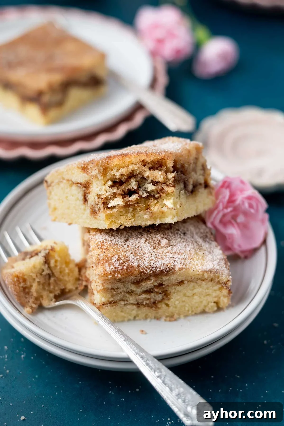two slices of churro cake on a plate with a fork