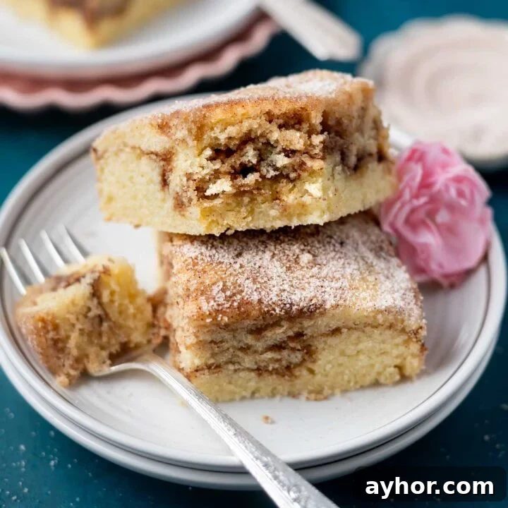 two slices of churro cake on a plate with a fork