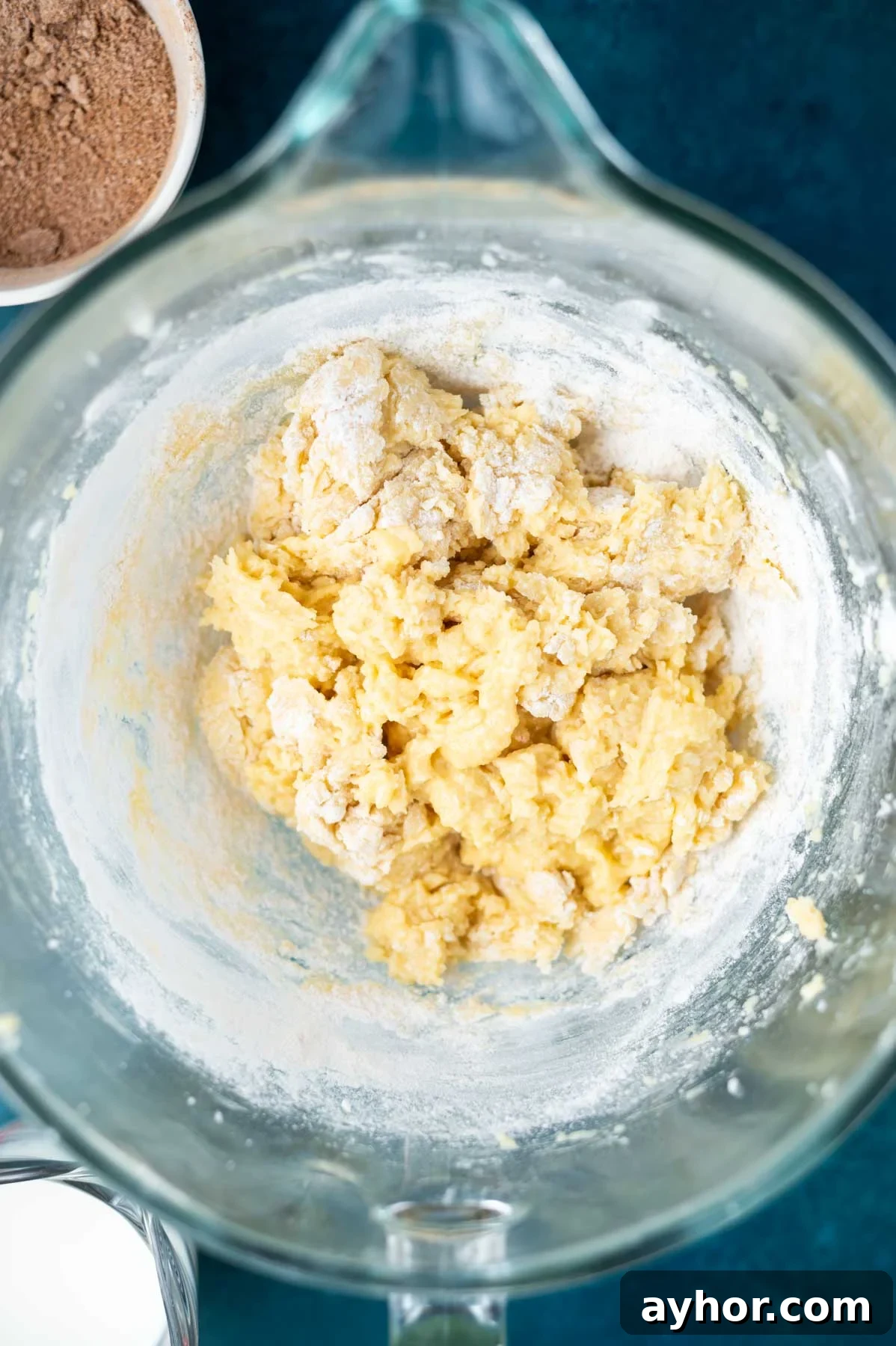 cake batter before the milk is added in a mixing bowl