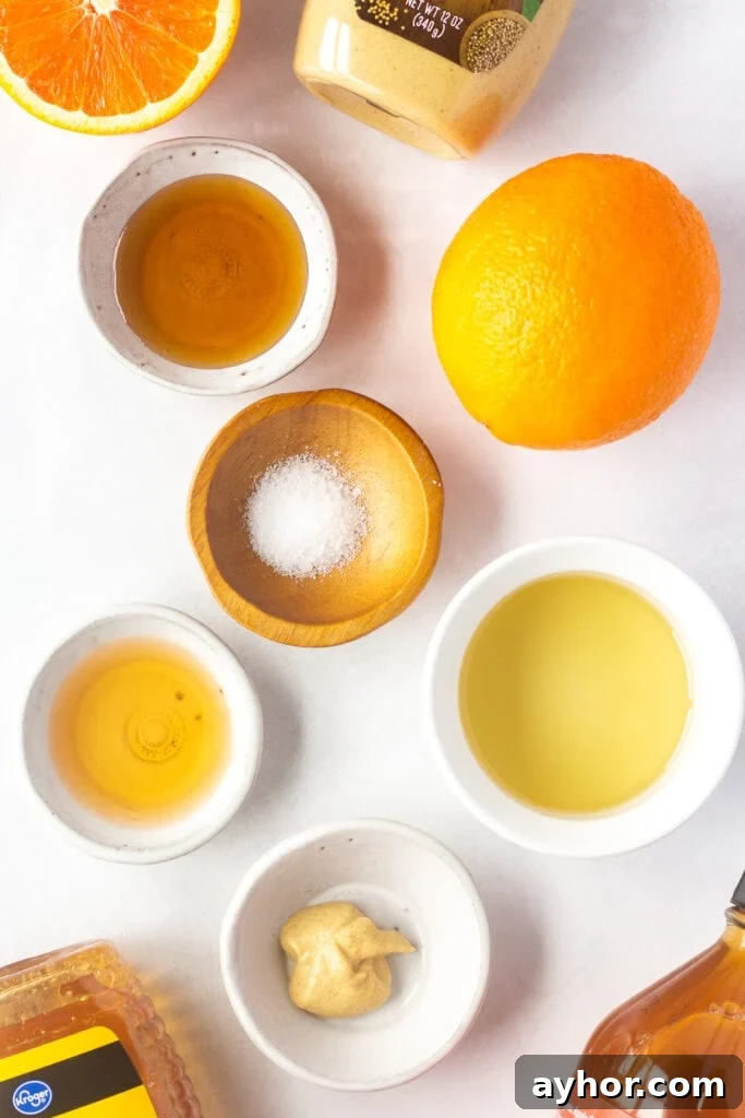 Honey Orange Vinaigrette with 6 Simple Ingredients 3 Top down shot of ingredients for honey orange vinaigrette in small white bowls on a white background.