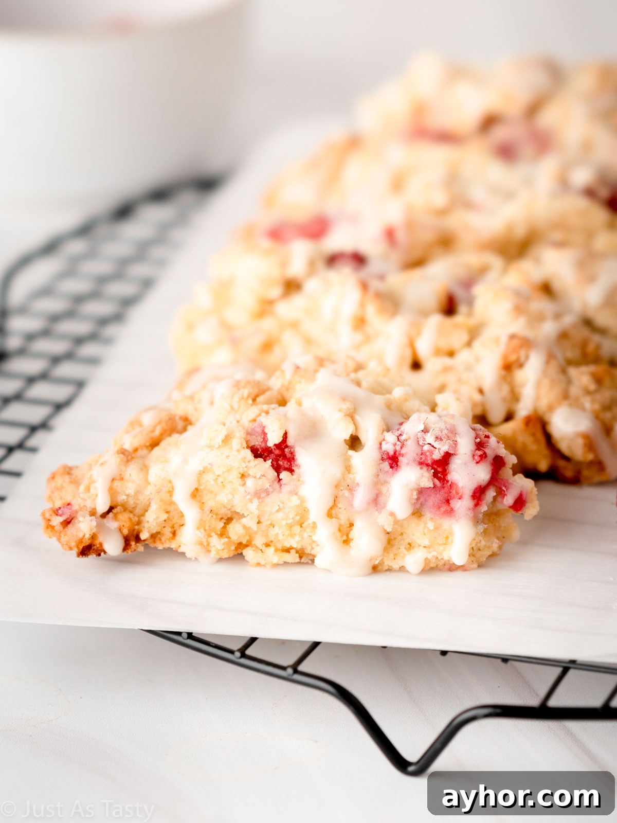 White Chocolate Raspberry Scones Recipe - Tender Morning Treat 3 Close-up of a glazed white chocolate raspberry scone.