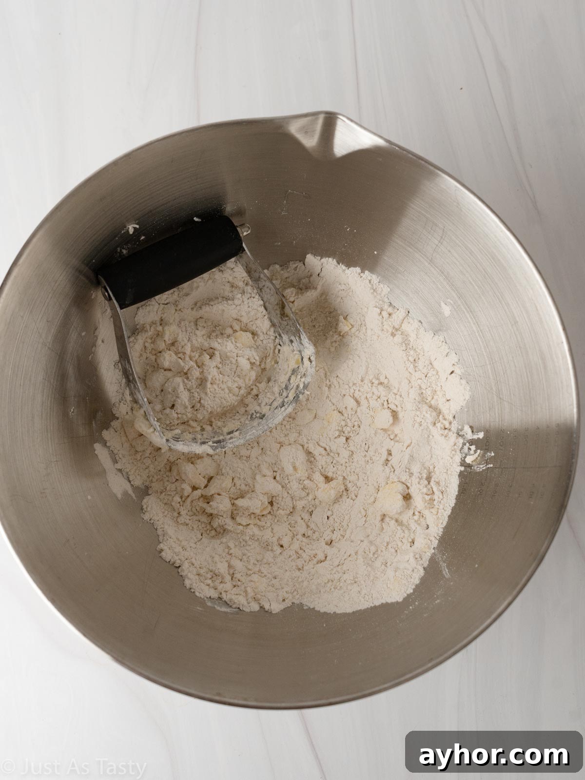 White Chocolate Raspberry Scones Recipe - Tender Morning Treat 6 Dry ingredients with butter in a bowl.