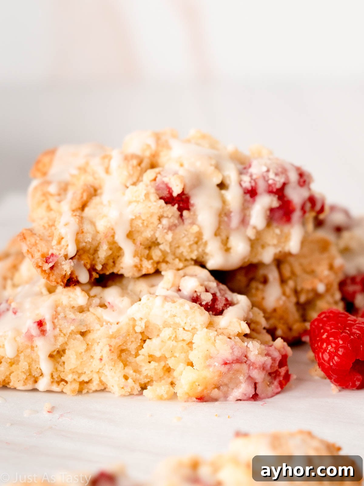 White Chocolate Raspberry Scones Recipe - Tender Morning Treat 10 White chocolate raspberry scones stacked on top of each other.