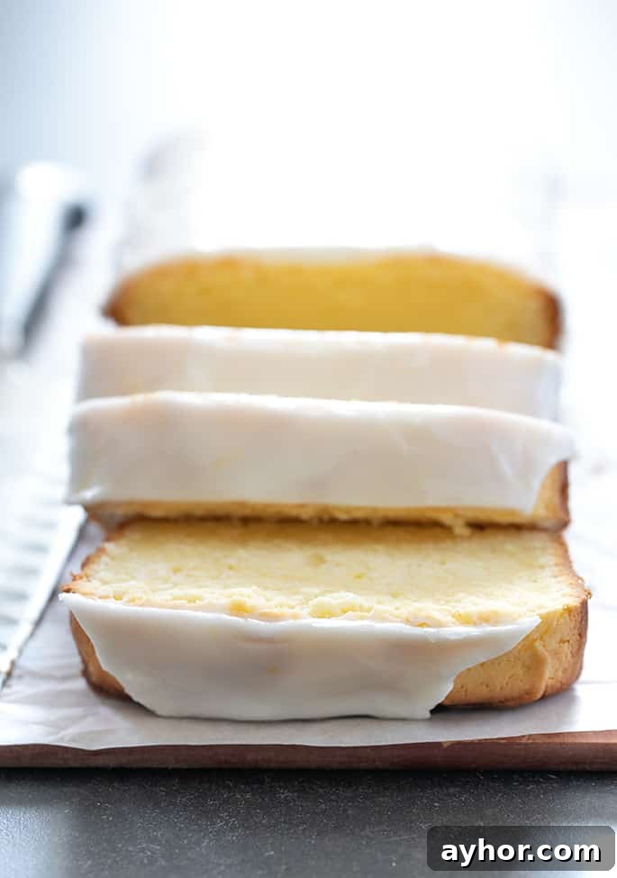 Glazed Gluten-Free Lemon Pound Cake Recipe 2 Baked, iced and sliced gluten free lemon pound cake, closeup image