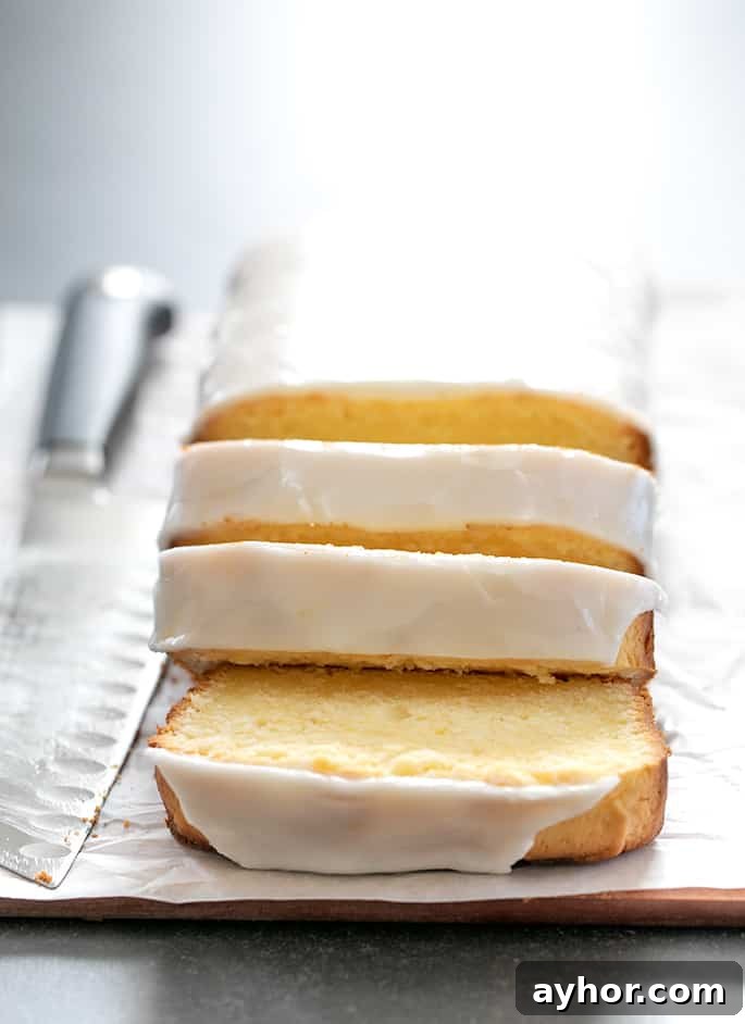 Glazed Gluten-Free Lemon Pound Cake Recipe 9 Image of baked, iced, and sliced gluten free lemon pound cake.