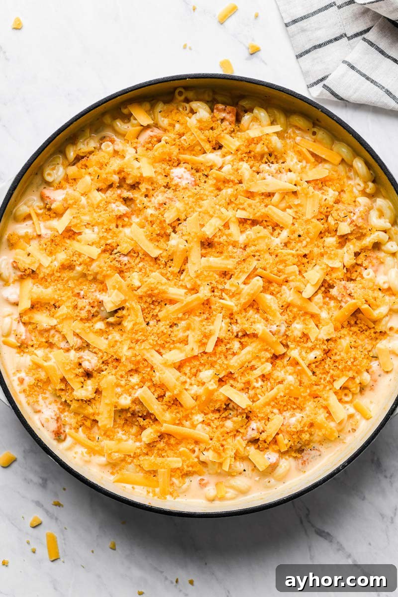 man n cheese topped with cheese and bread crumbs in a skillet