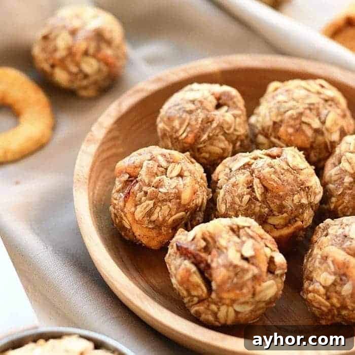 These Apple Chai Energy Balls are made with rolled oats, dried apples, chai spices, and an almond butter base for a healthy fall sweet treat. Great for snacks on the go! apple chai energy balls in a bowl