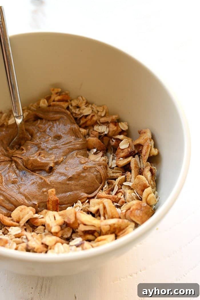 These Apple Chai Energy Balls are made with rolled oats, dried apples, chai spices, and an almond butter base for a healthy fall sweet treat. Great for snacks on the go! apple chai energy balls ingredients in a bowl