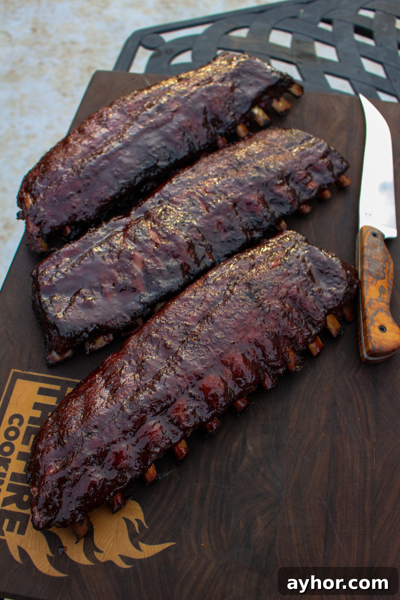 Maple-Cajun Smoked Ribs Recipe for Tender, Flavorful BBQ 4 Ribs sitting on the cutting board.