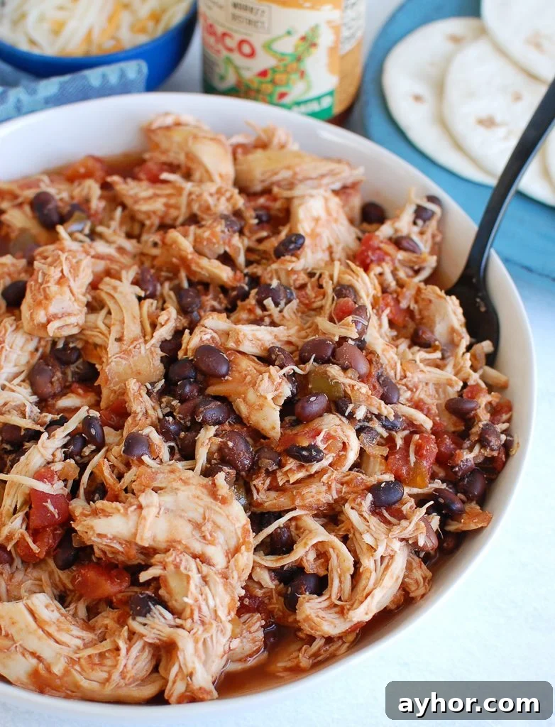 Tender Slow Cooker Shredded Chicken Recipe for Meal Prep 2 Slow Cooker Shredded Chicken in a white bowl