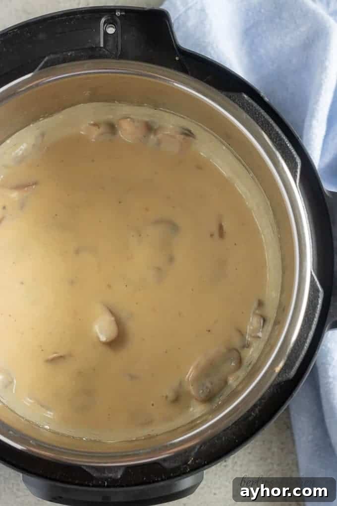 Instant Pot Pork Chops in Creamy Mushroom Gravy 6 The last Instant Pot pork chops picture showing the finished mushroom gravy, just before the dish is served.