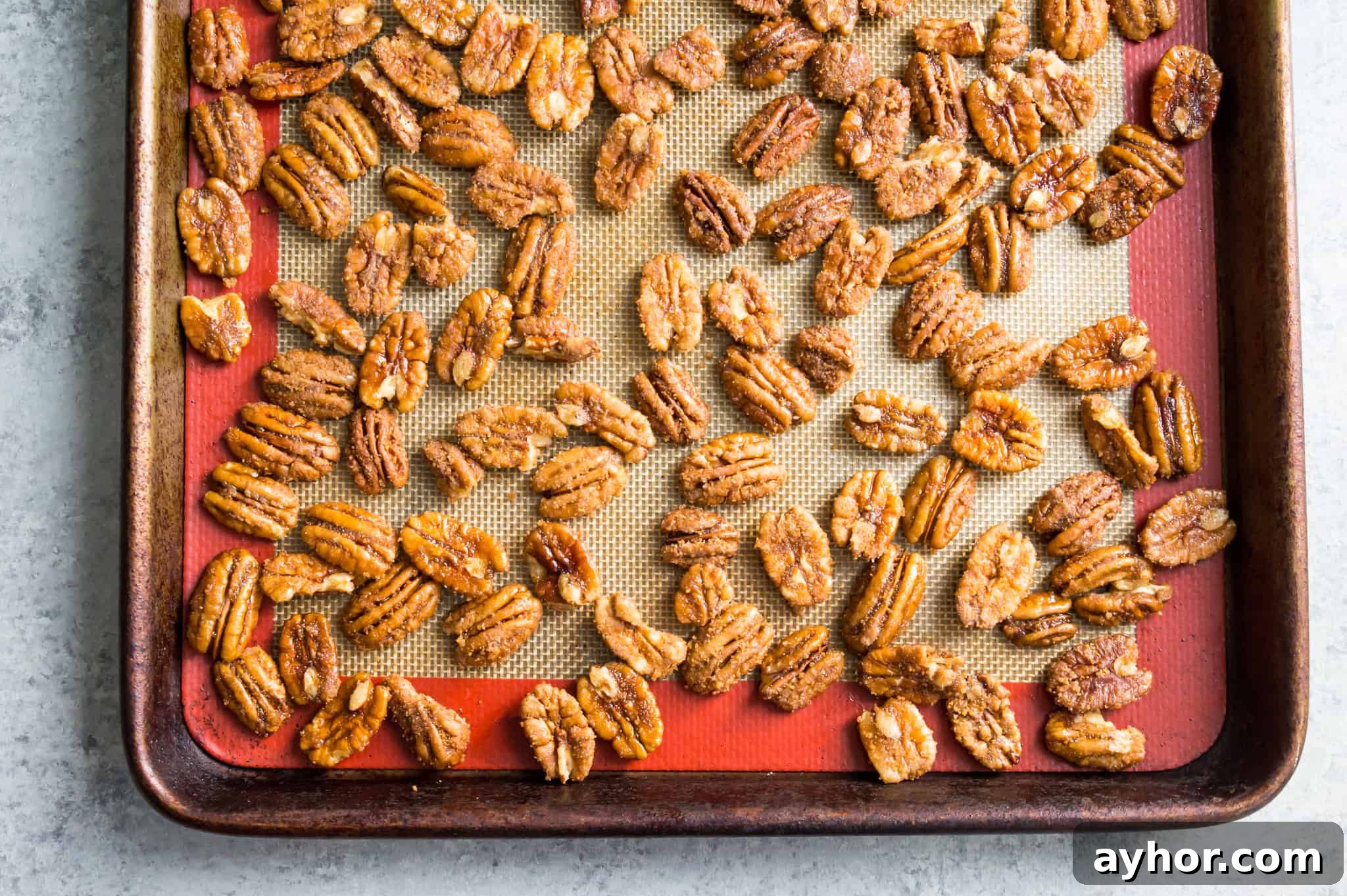 Homemade Chocolate-Covered Pecans: Simple No-Bake Recipe 5 Roasted pecans on a baking sheet.