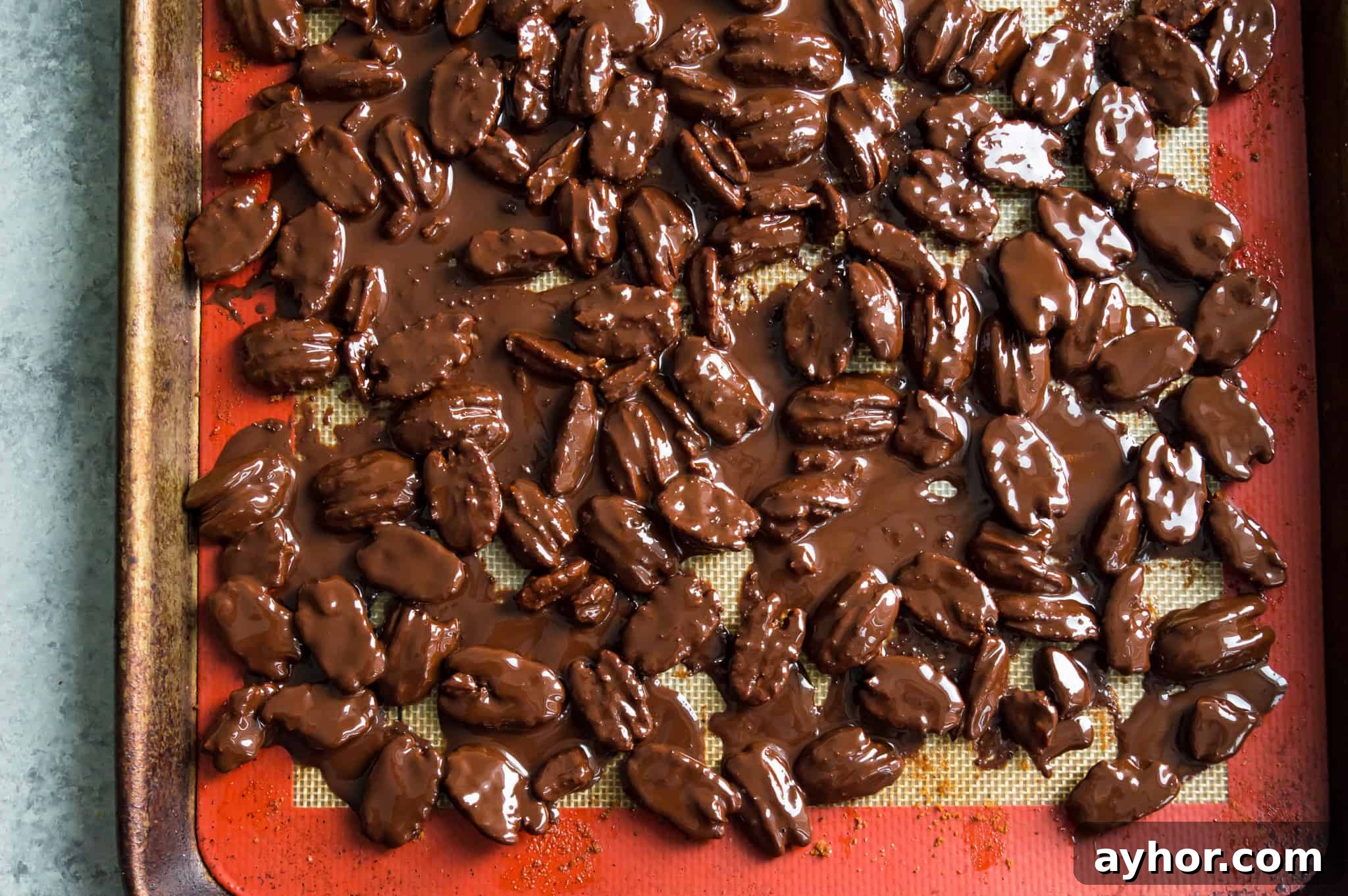 Homemade Chocolate-Covered Pecans: Simple No-Bake Recipe 7 A baking sheet with chocolate covered pecans on it.
