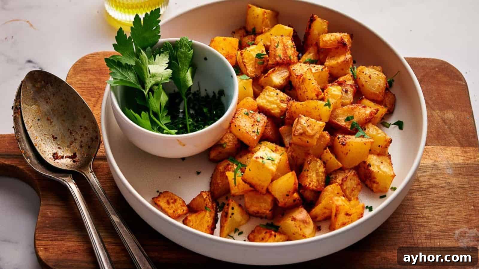 29 Breakfast Recipes to Make Your Mornings Feel Romantic 16 Breakfast potatoes with parsley on a wooden cutting board.