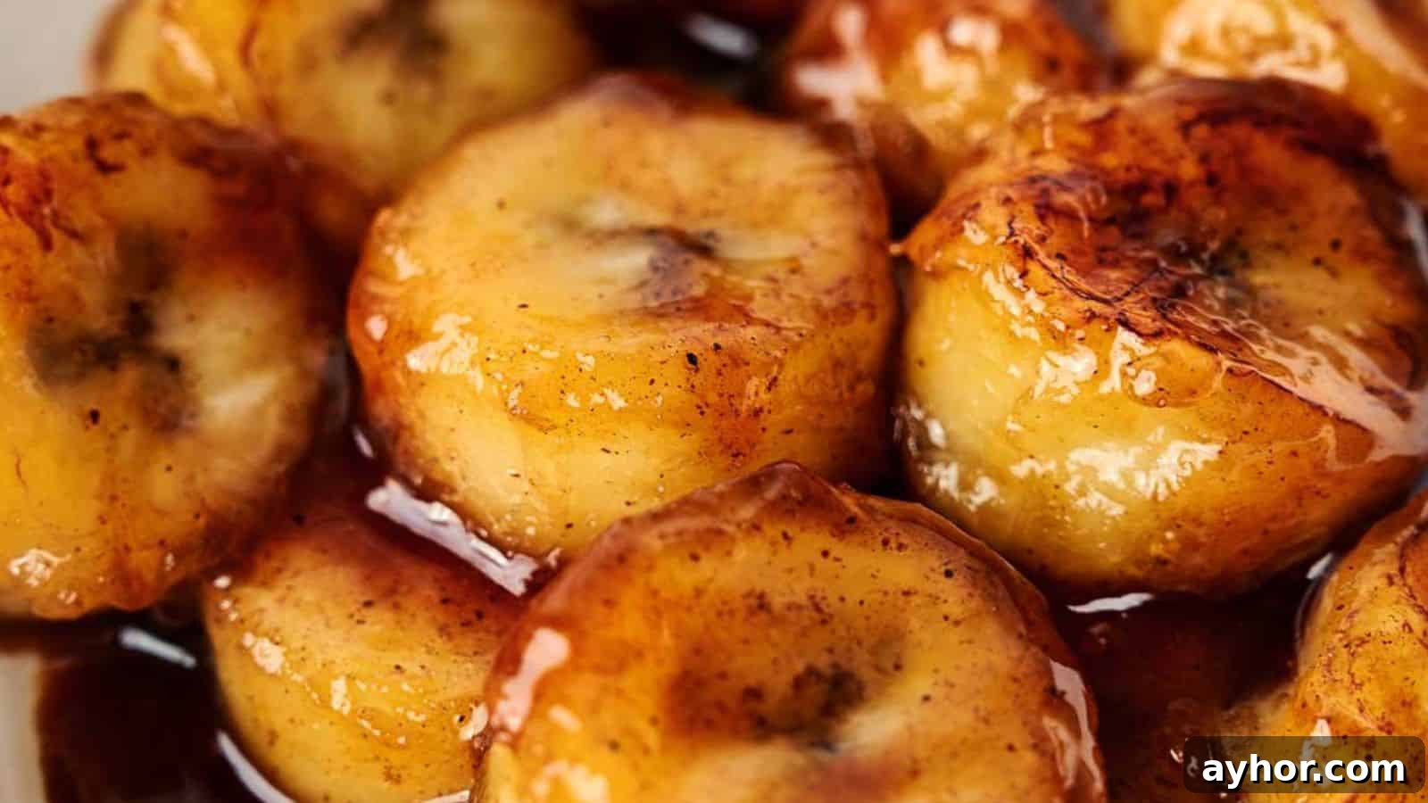 29 Breakfast Recipes to Make Your Mornings Feel Romantic 22 A close up of a plate of fried bananas with sauce.