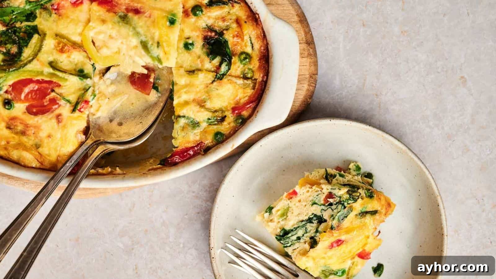 29 Breakfast Recipes to Make Your Mornings Feel Romantic 25 A plate with a slice of Egg & Potato Breakfast Casserole and a fork.