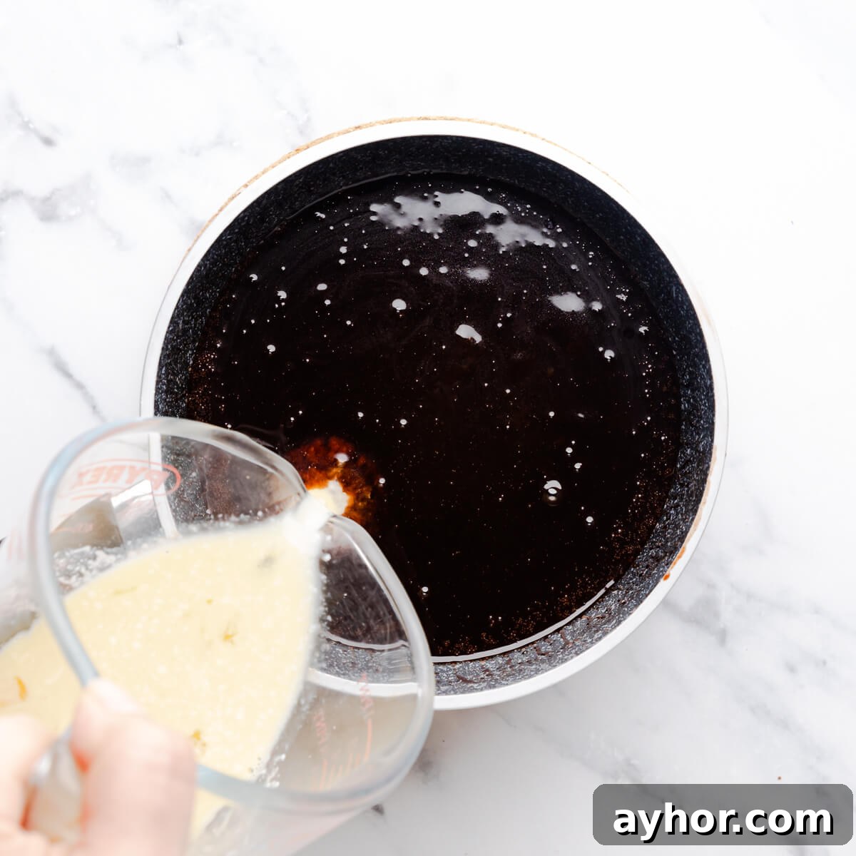 wet ingredients for the chocolate Guinness cake being mixed together in a small saucepan.