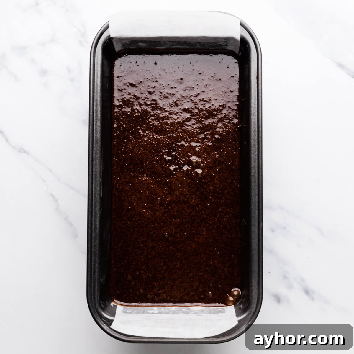 small loaf tin with cake batter inside.