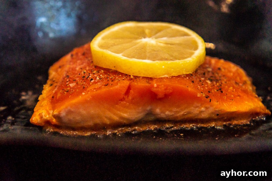Pan-Seared Salmon in a Cast-Iron Skillet: Crispy Skin, Tender Flesh 4 salmon cooking in a cast iron pan