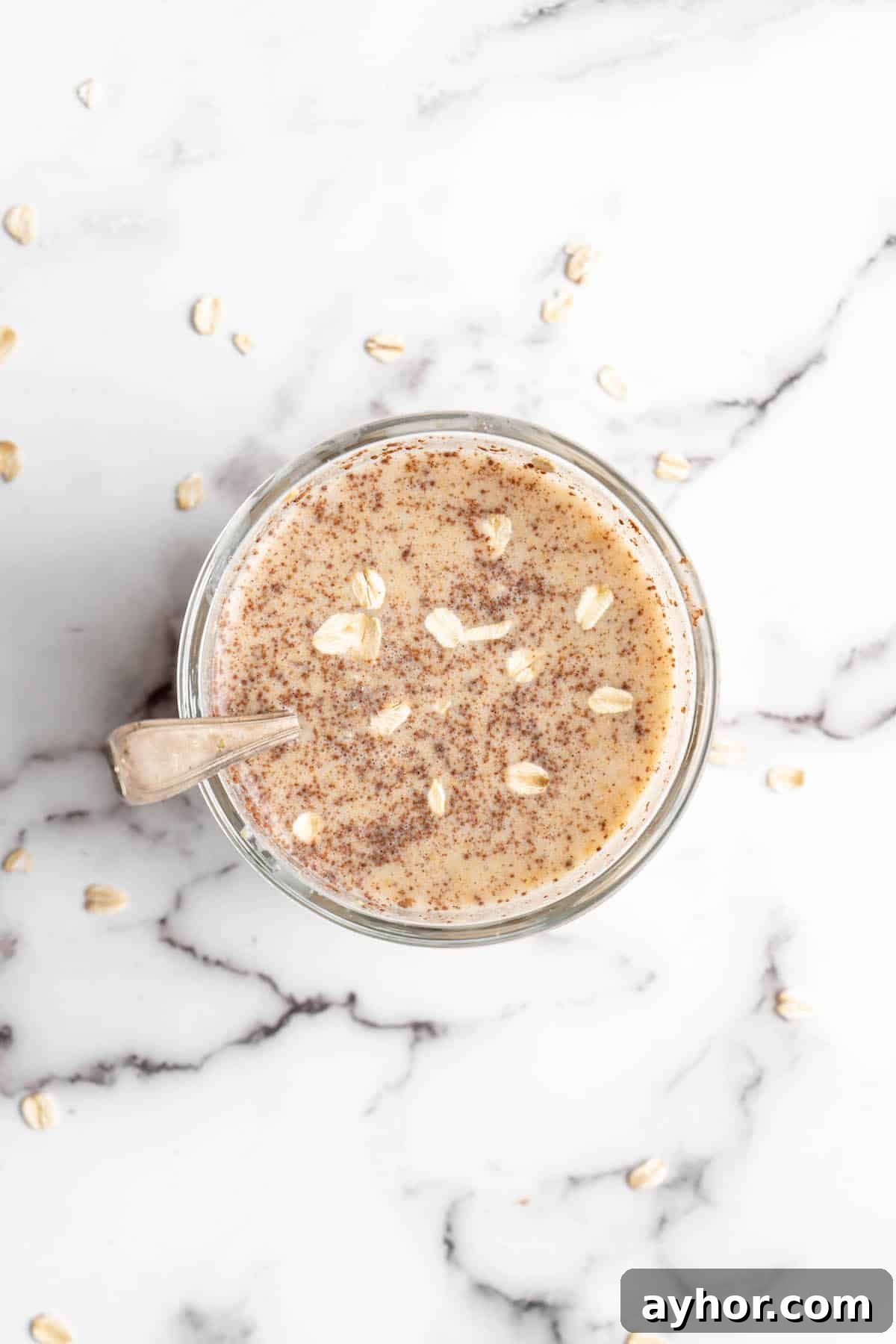 Overhead view of overnight oats in jar with spoon