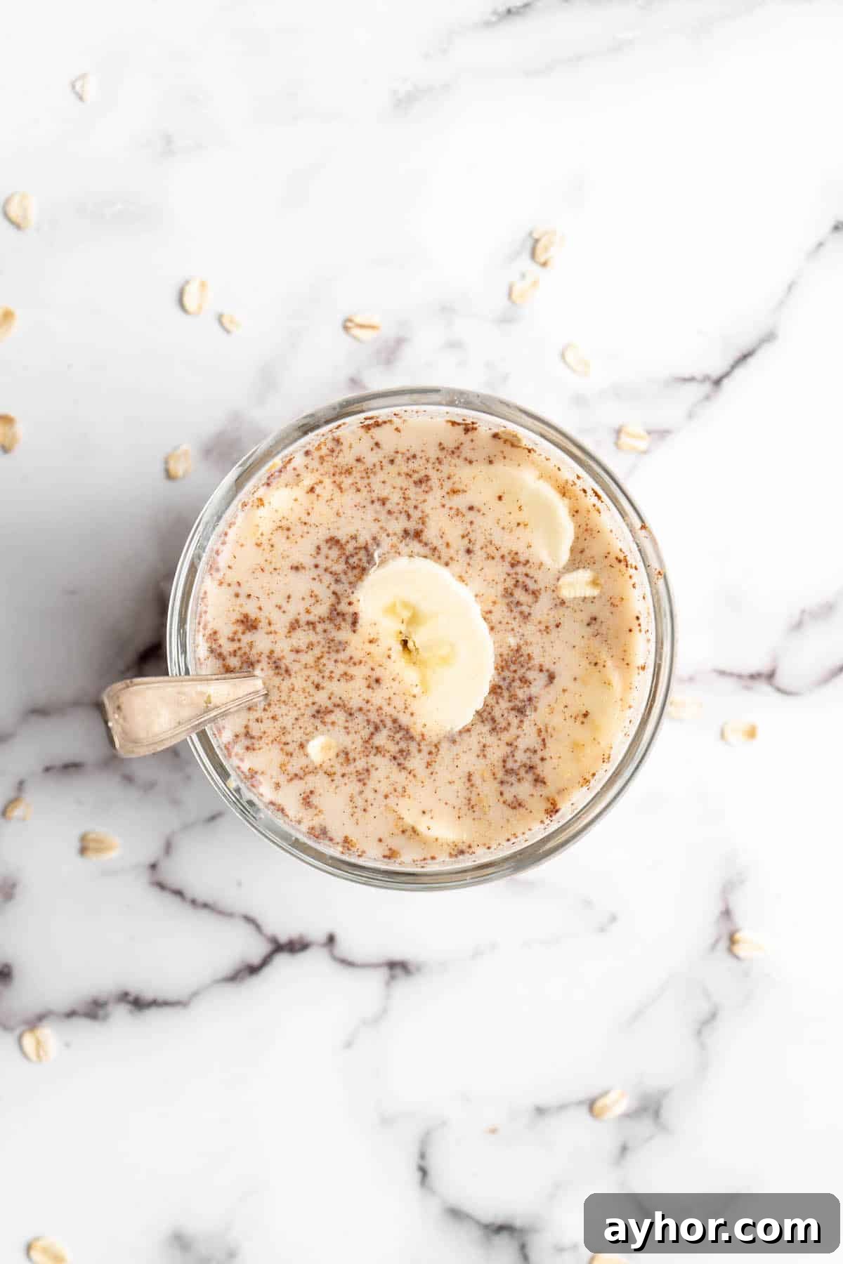 Overhead view of overnight oats in jar with spoon