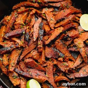 square image of carne asada made vegan in a black pan