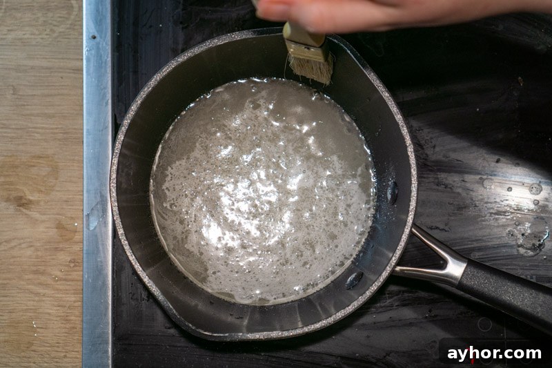 Brushing down the sides of the pan